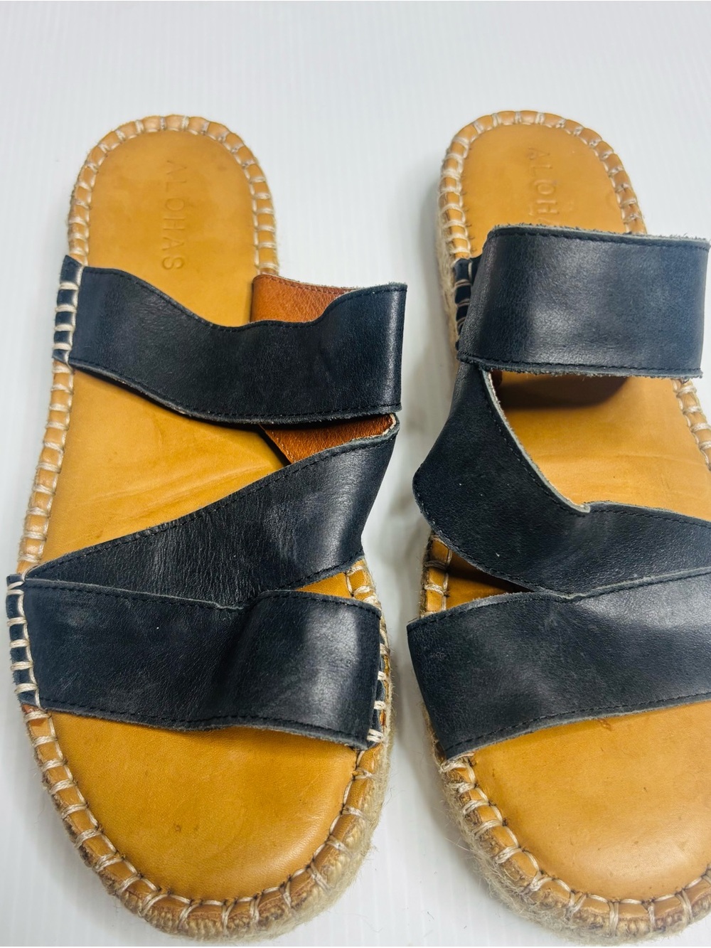 ALOHAS black leather crossover espadrille slides.